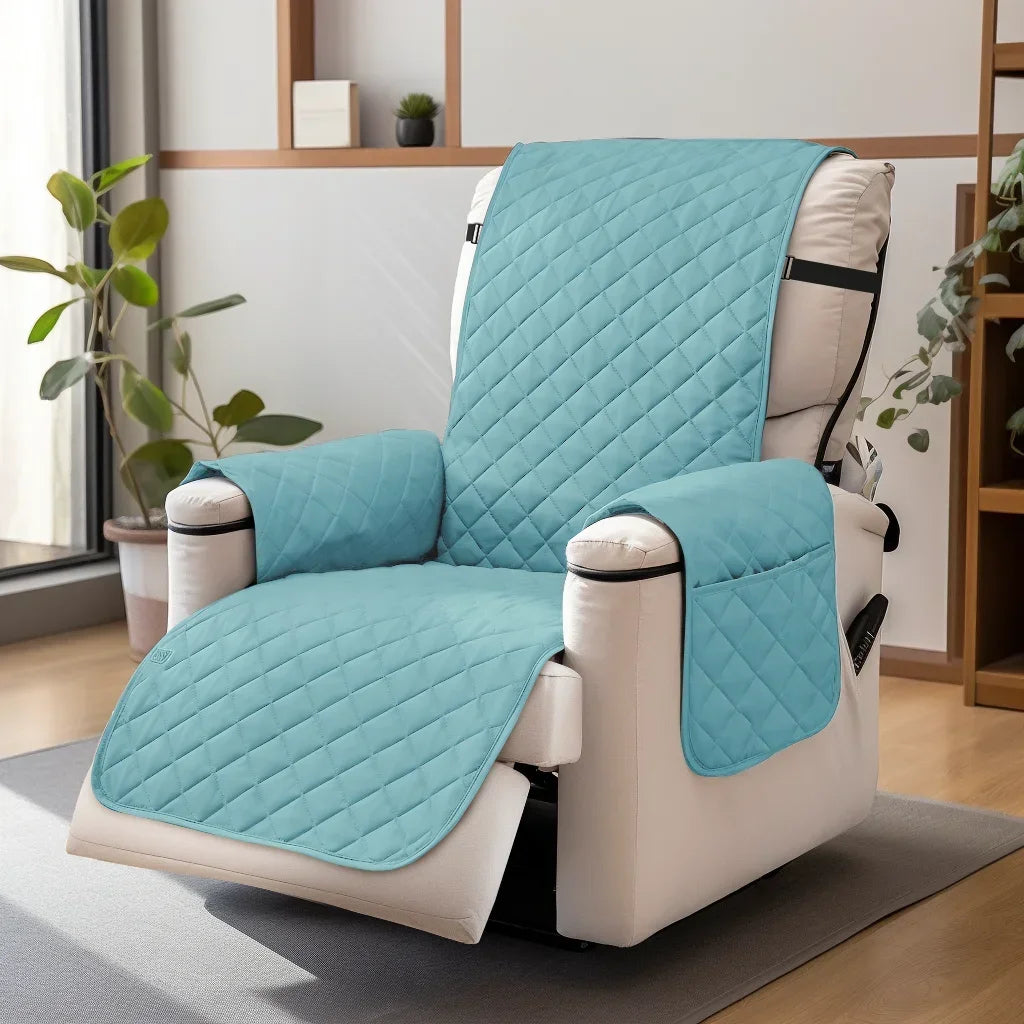 A teal quilted recliner sofa cover with side pockets displayed on a light-colored chair.