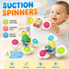 A baby is playing with suction spinner toys designed for sensory play and teething.