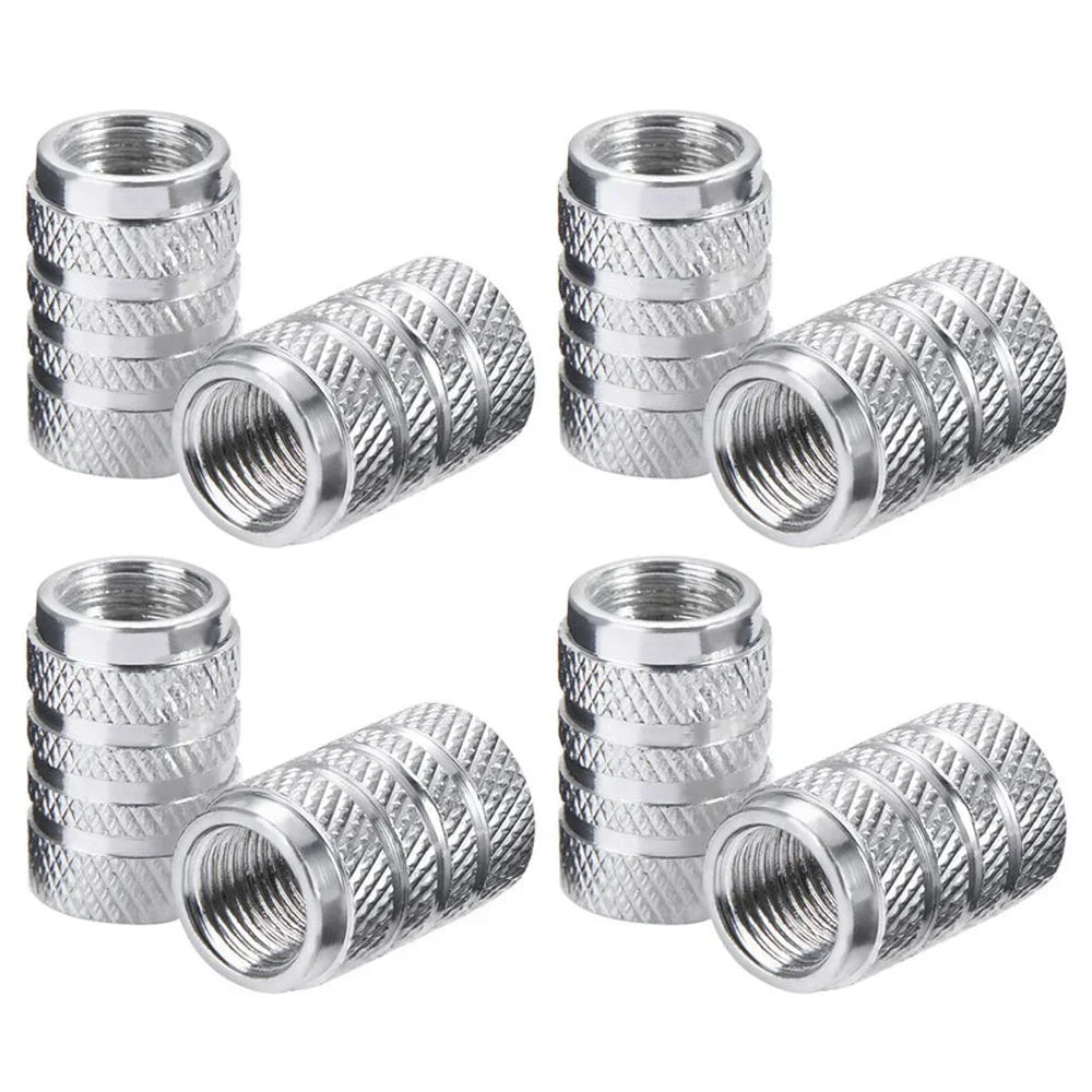 A set of four knurled aluminum tire valve caps shown in various views.