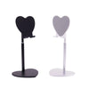 A black adjustable heart-shaped stand for holding a phone or tablet.