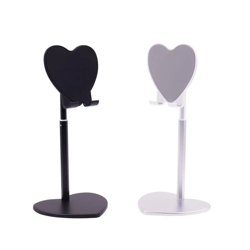 A black adjustable heart-shaped stand for holding a phone or tablet.