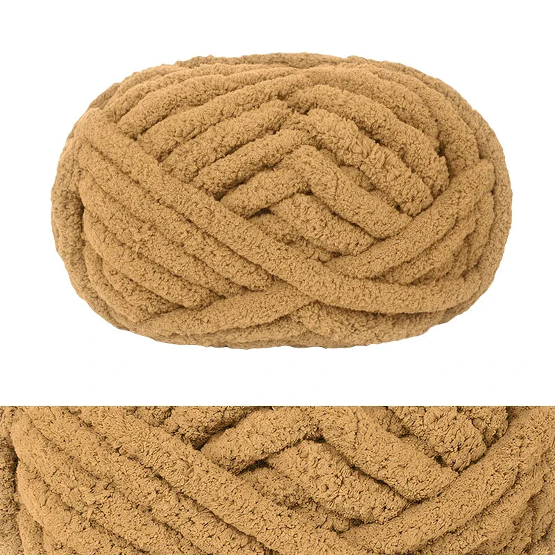 A ball of chunky chenille yarn in a warm tan or beige color.