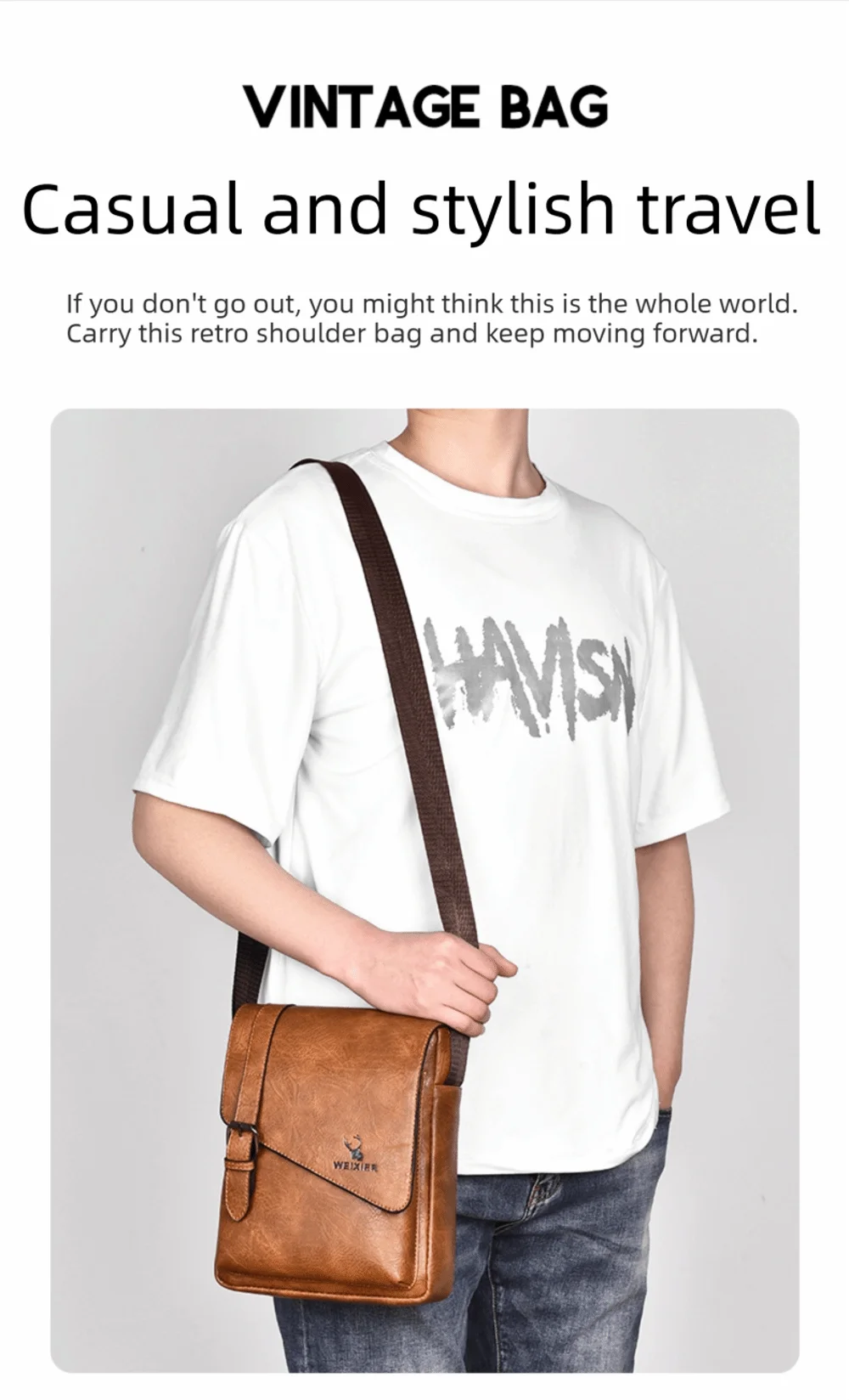 A man wearing a white t-shirt and jeans carrying a brown vintage leather messenger bag across his body.