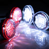 A close-up of several bright red LED headlights and spotlights reflecting on a surface.