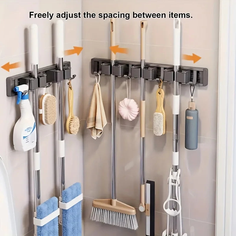 Wall-mounted metal holder for mop and broom with detachable hooks for organizing cleaning tools.