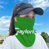 A person wearing a bright green neck gaiter with the word Jaylorl visible, outdoors under a blue sky.