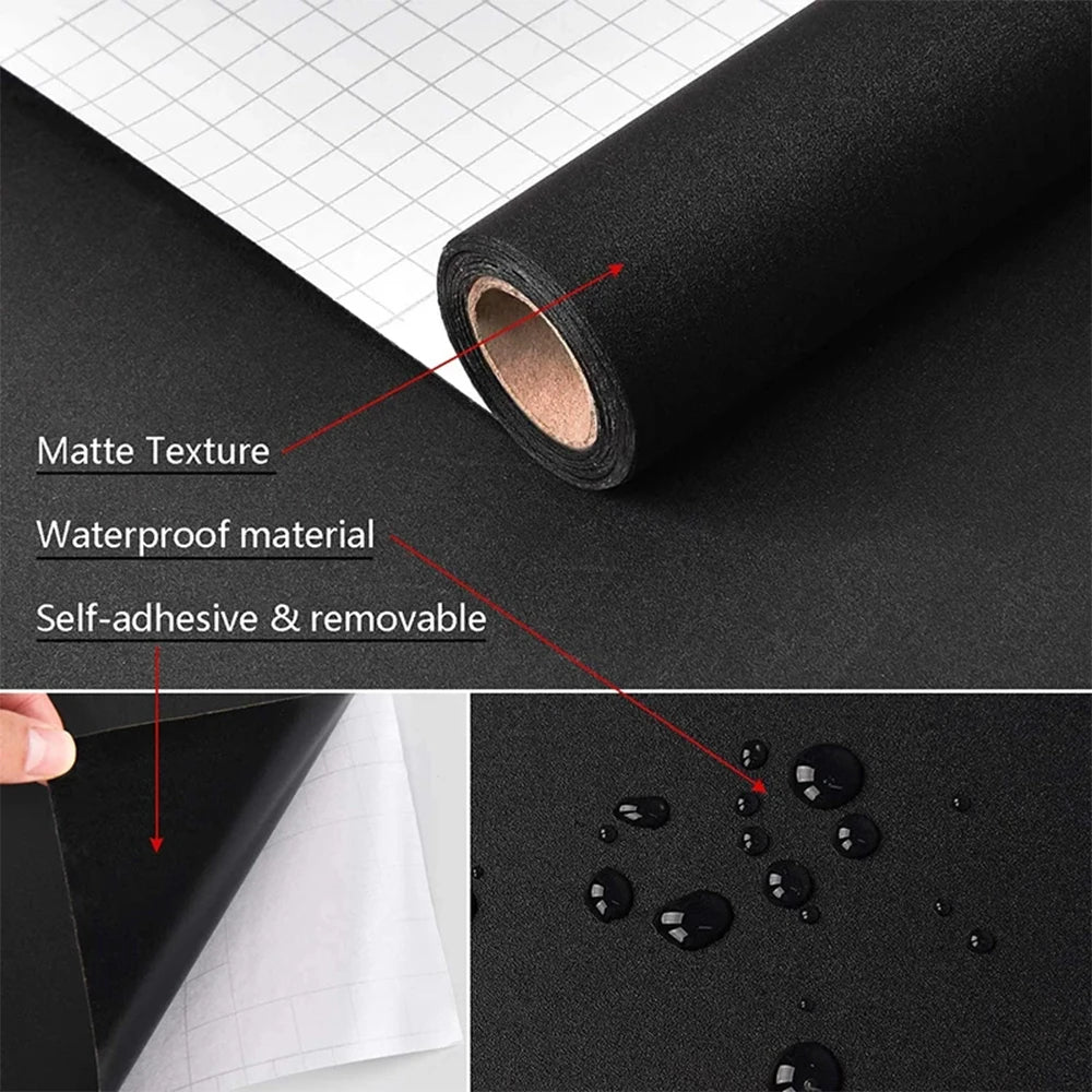 Roll of self-adhesive matte black waterproof vinyl wallpaper next to a sheet of graph paper.