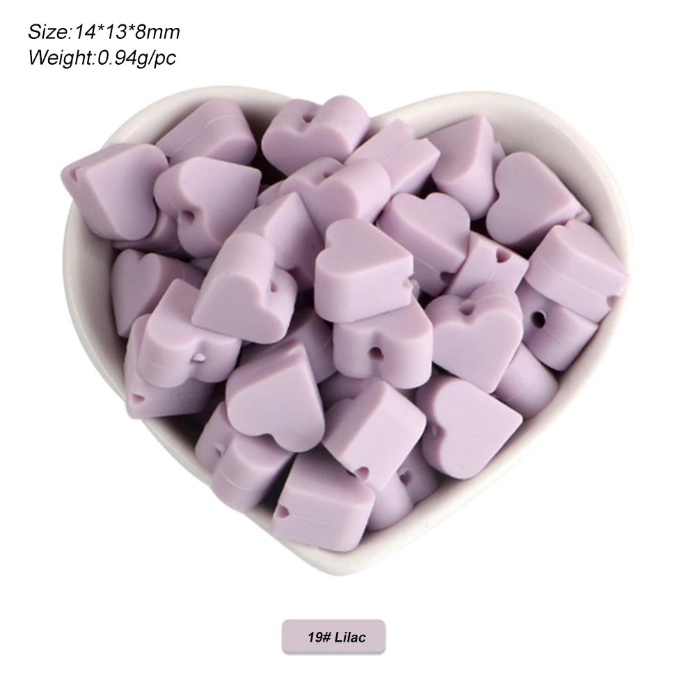 A pile of lilac silicone crown star heart beads for DIY jewelry making