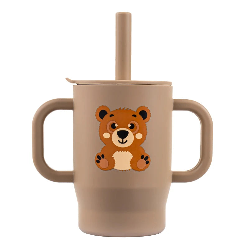 A beige silicone training cup for babies featuring a cute orange bear design, complete with a straw and handles.