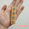 A hand holds a clear plastic keychain featuring multiple custom LED mechanical keycaps.