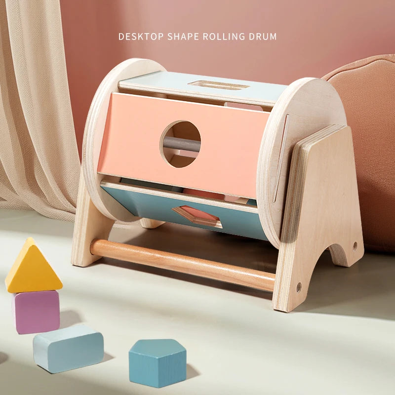 A wooden desktop shape rolling drum toy featuring colorful blocks and a soothing ring.