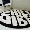A round black and white letter carpet featuring the words CHILL VIBES in large, textured letters.