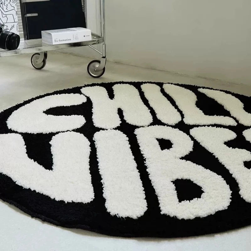 A round black and white letter carpet featuring the words CHILL VIBES in large, textured letters.