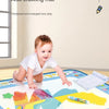 A large reusable water drawing mat with various colorful items and magic pens laid out on a wooden table.