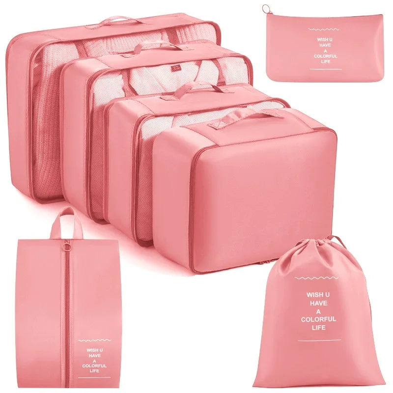A set of pink travel packing cubes and storage organizer bags for clothing.