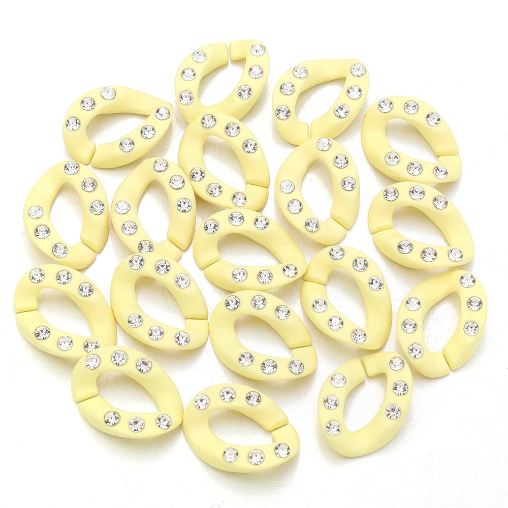 A set of twenty yellow acrylic jewelry connector clasps with crystal accents.