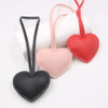 Three heart-shaped PU leather keychains in pink, red, and black with cotton charms
