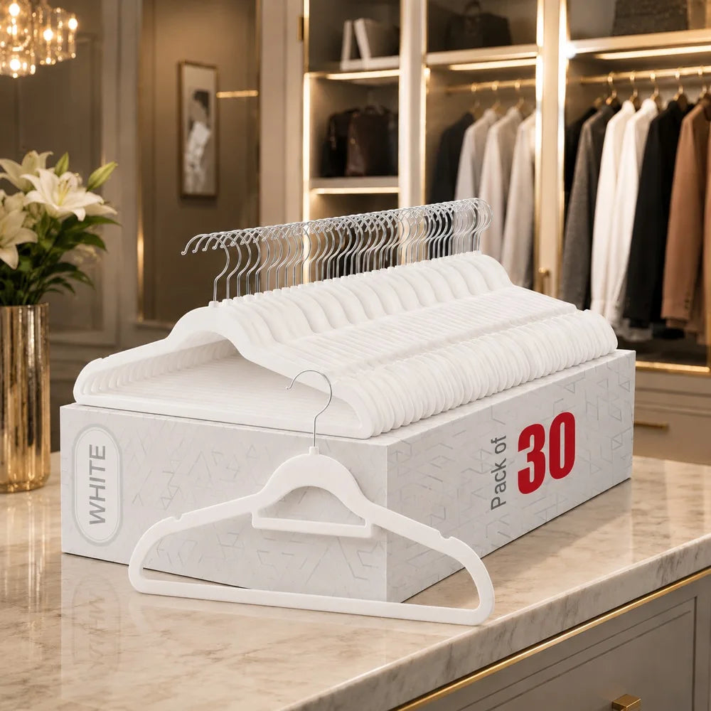 A white box of velvet non-slip hangers with 360° rotating hooks displayed on a marble surface.