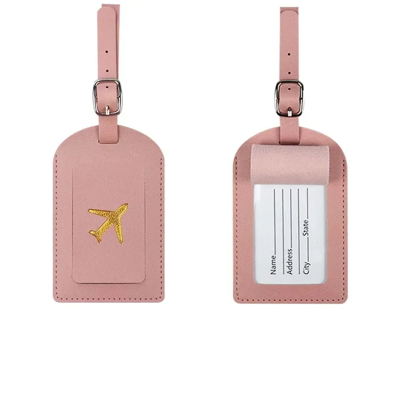 A pink PU leather luggage tag with a gold airplane design and a clear section for address information.