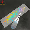 A silver vinyl decal featuring wildstyle graffiti lettering is shown on a dark surface.