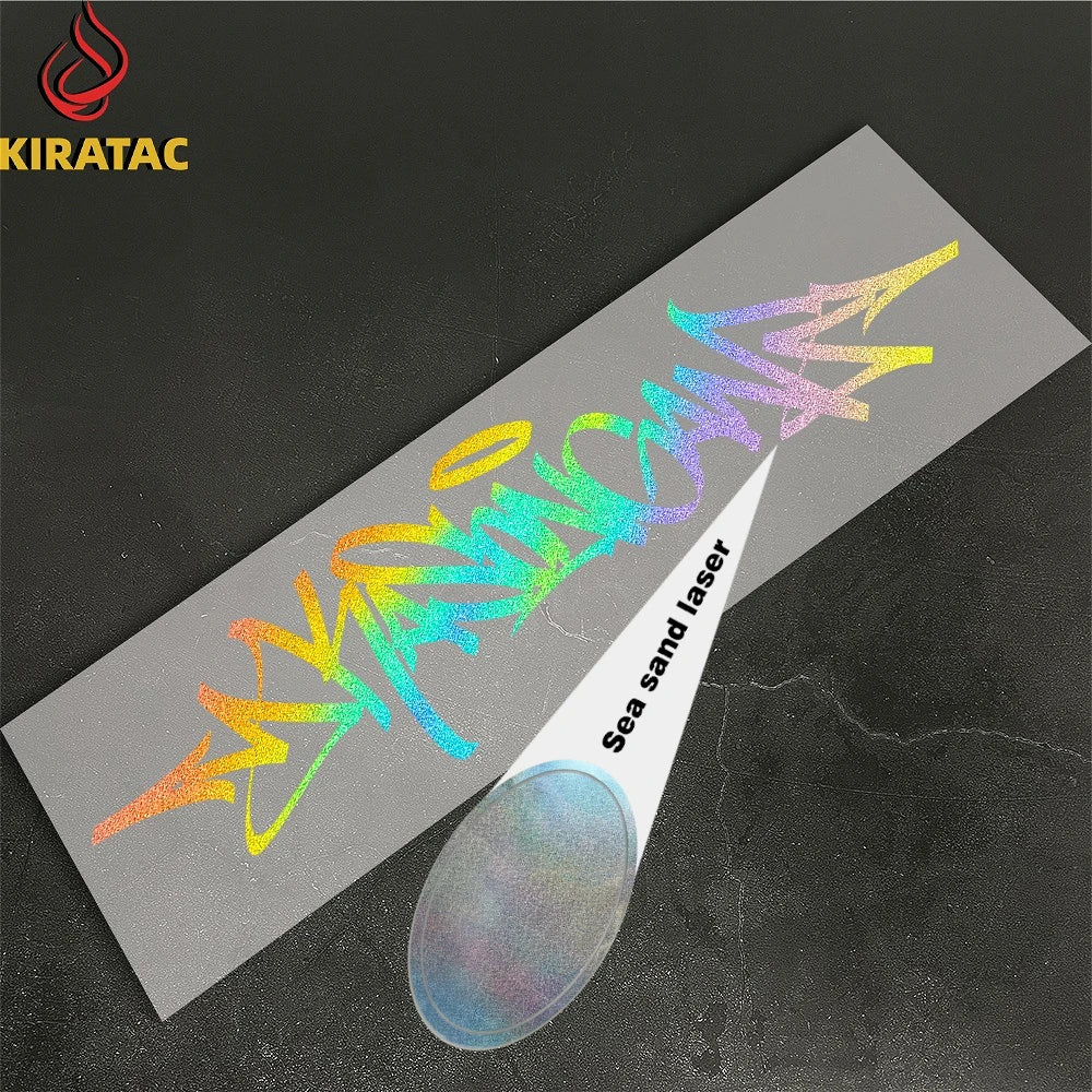 A silver vinyl decal featuring wildstyle graffiti lettering is shown on a dark surface.