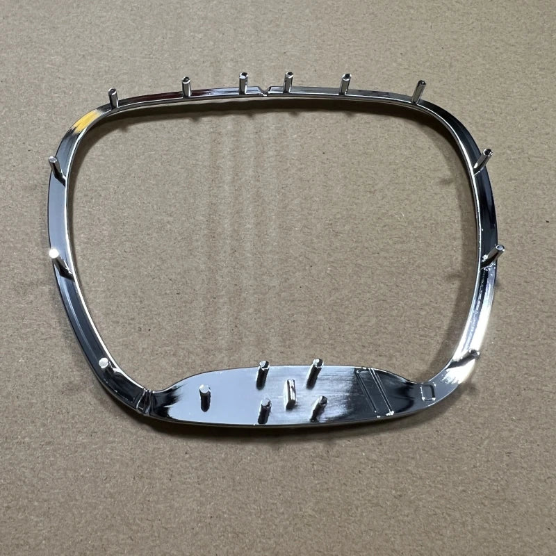 Silver steering wheel cover with spikes and emblem