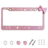 Pink rhinestone license plate frame with a bow accent and small components