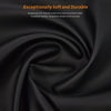 A close-up shot of soft black faux leather material being tightly rolled.