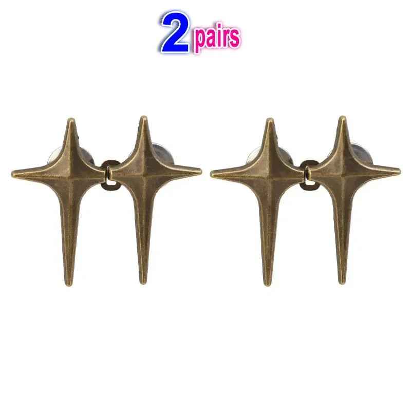 A pair of brass Y2K star waist tightener clips for jeans.