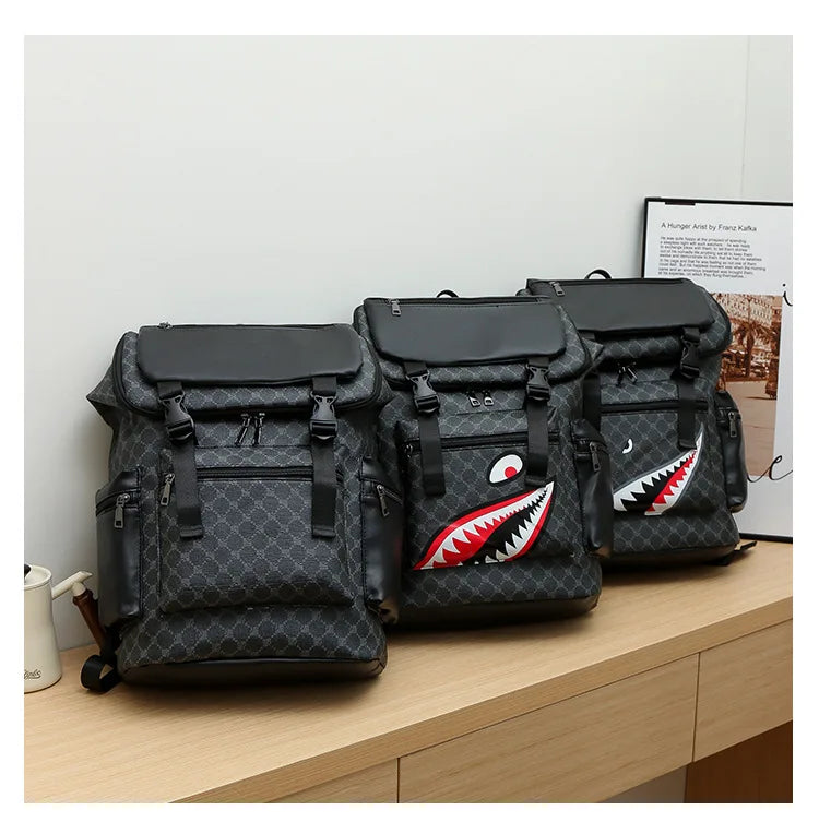 A black shark-inspired PU leather backpack is shown on a wooden surface.