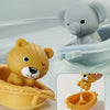 A yellow lion silicone finger puppet bath toy is shown next to a gray elephant bath toy.