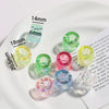 A collection of colorful acrylic alphabet beads of various sizes displayed on a white plate.
