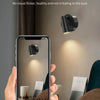 A hand holds a smartphone displaying a soft light fixture, illustrating eye protection features.