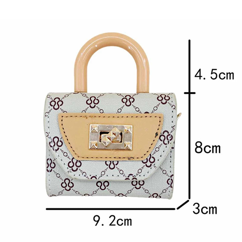 A mini floral textured crossbody tote bag in white and purple with a beige handle and square silver hardware.