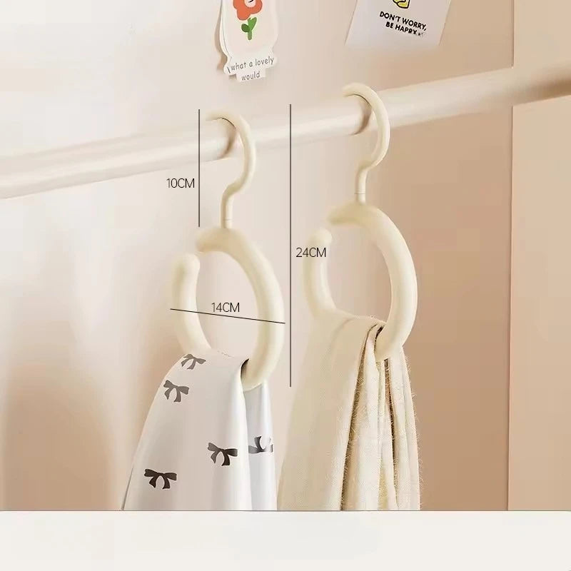 A white Nordic wall-mounted organizer hook displaying a hat and scarf hanging on a light-colored shelf.