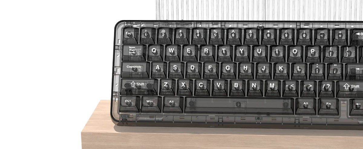 A close-up view of a black mechanical keyboard with crystal clear keycaps and RGB backlighting resting on a wooden surface.
