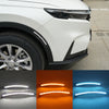 Close-up view of LED daytime running lights and dynamic turn signal housing on a white Honda CR-V.