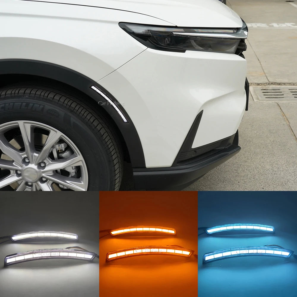 Close-up view of LED daytime running lights and dynamic turn signal housing on a white Honda CR-V.