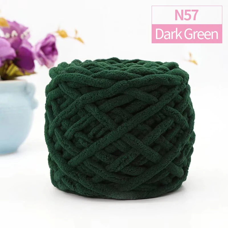 A ball of dark green N57 chunky chenille yarn used for knitting or crocheting.