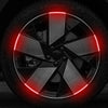 Close-up of a car wheel rim with red LED strips illuminating the spoke design.