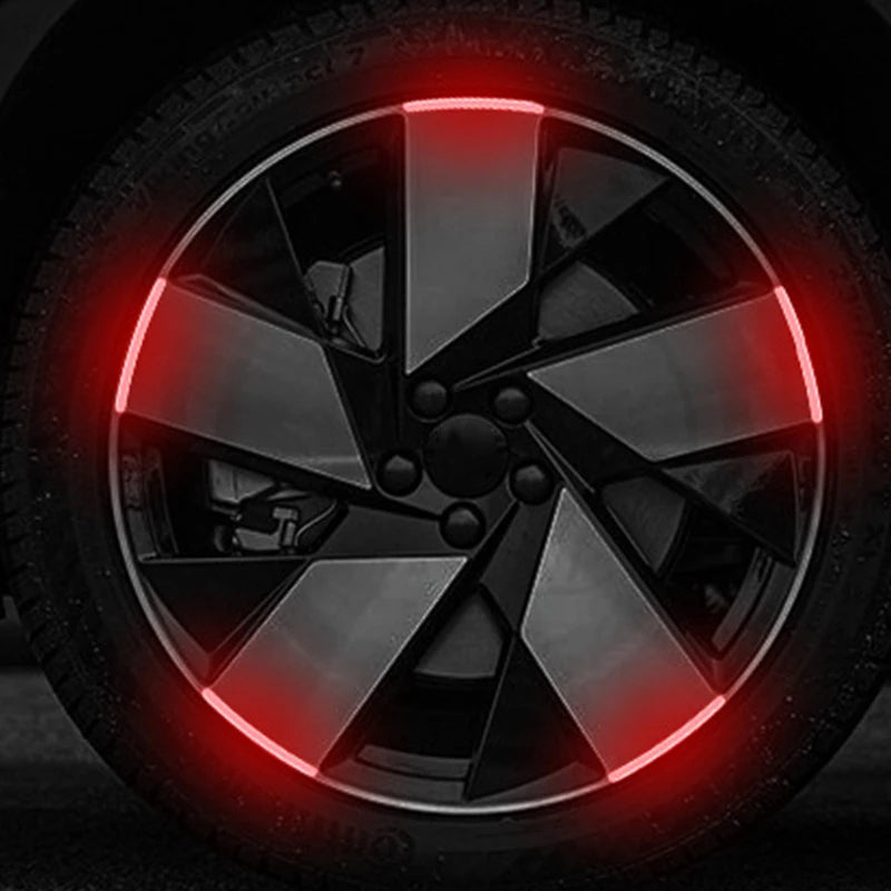 Close-up of a car wheel rim with red LED strips illuminating the spoke design.
