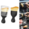 A black and wood-colored detailing brush used for cleaning car vents, seats, and gaps.