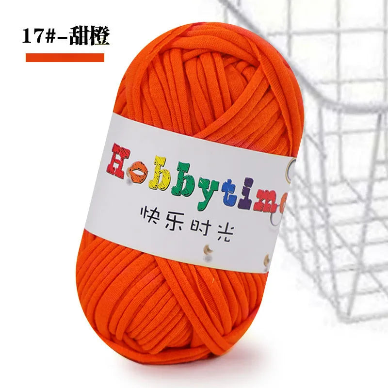 A ball of bright orange soft T-shirt yarn for crochet and knitting is shown against a white background.