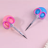 Pair of professional stainless steel cuticle scissors with curved blades in pink and blue.