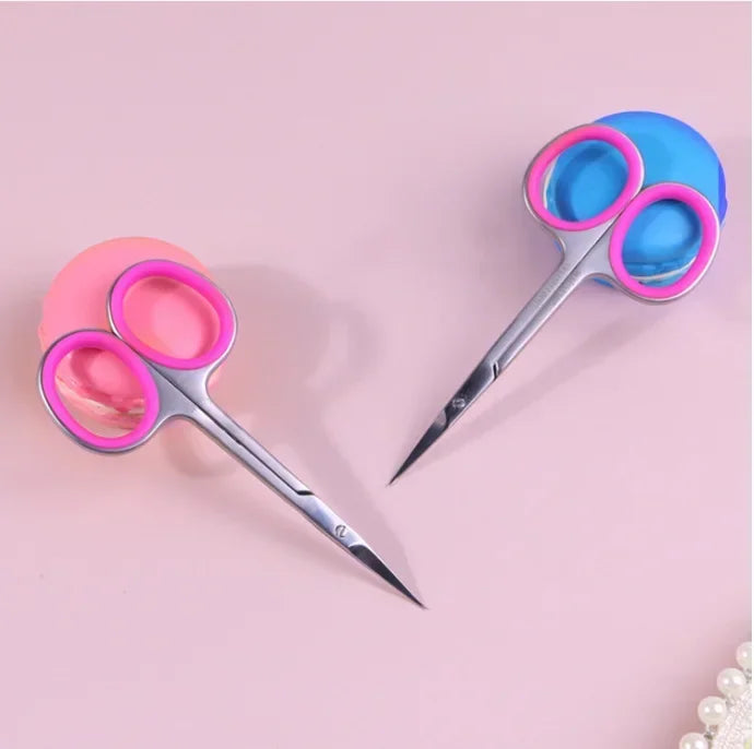 Pair of professional stainless steel cuticle scissors with curved blades in pink and blue.