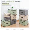A set of light green and gray fabric storage boxes stacked and arranged for closet or drawer organization.
