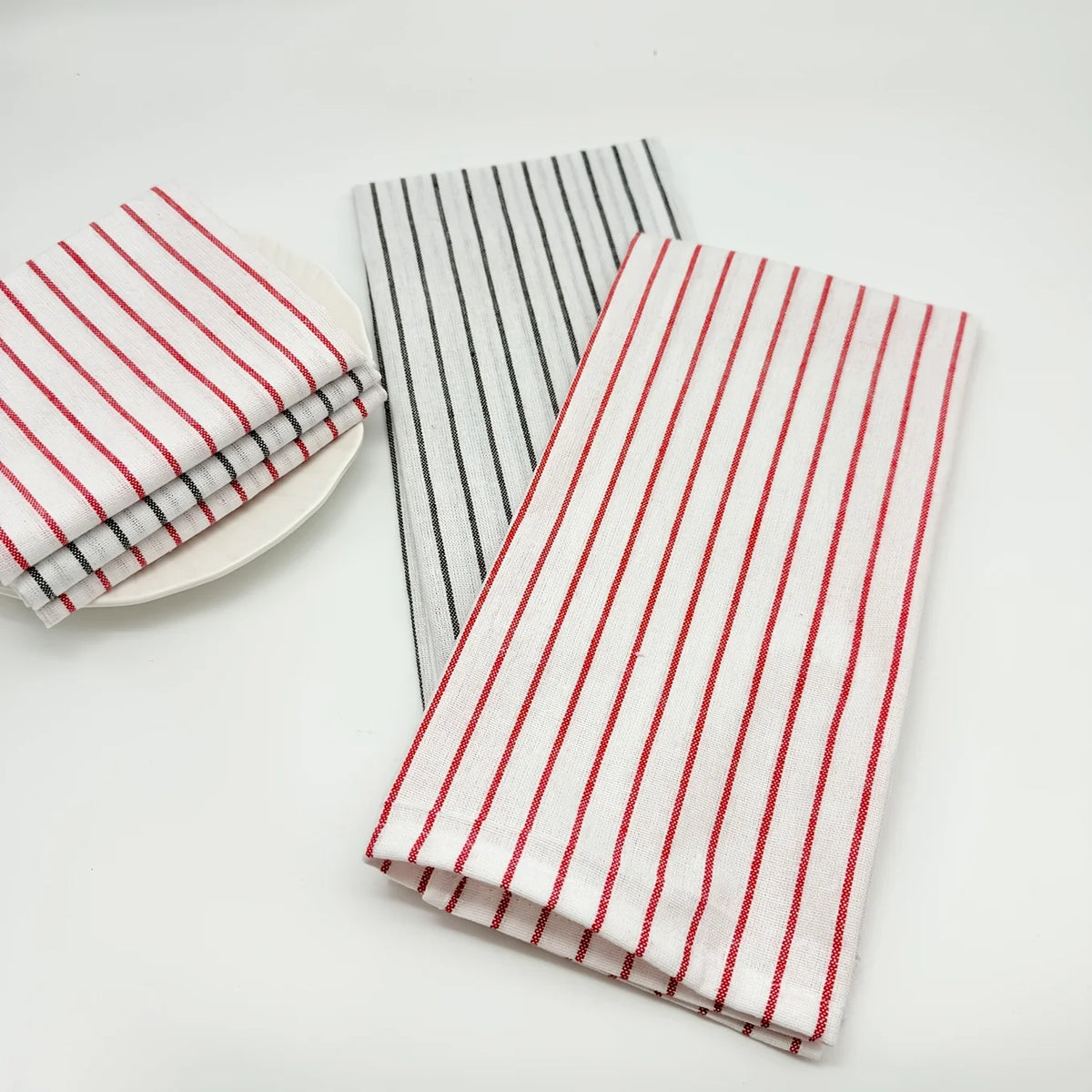 Two striped lint-free kitchen dishcloths are displayed, featuring red and black stripes.