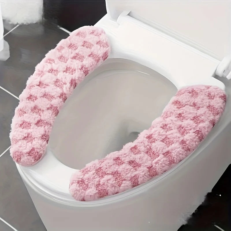 A plush pink winter toilet seat cushion cover is shown inside a white toilet bowl.
