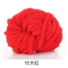 A ball of bright red chunky acrylic yarn for knitting and crochet