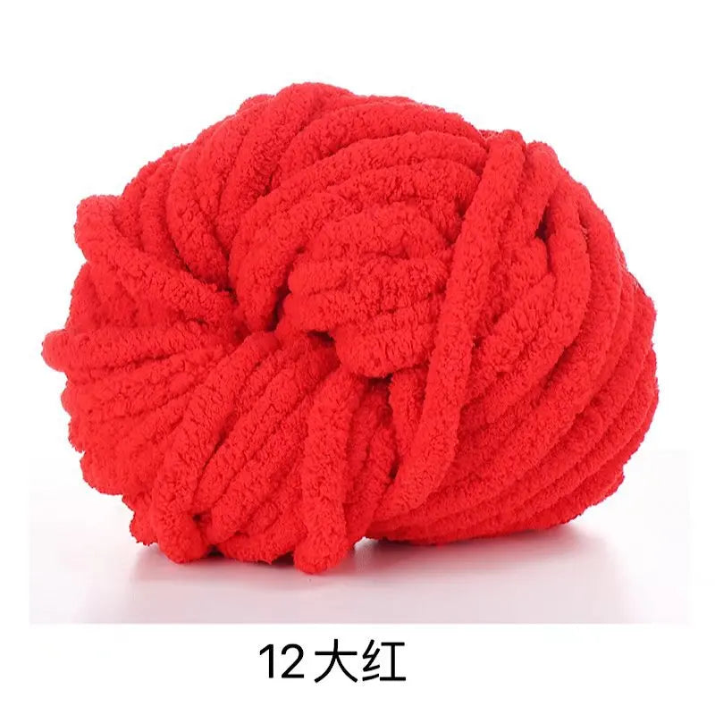 A ball of bright red chunky acrylic yarn for knitting and crochet